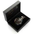 A luxurious black, octagonal perfume bottle with intricate gold embossed designs on the front, displayed inside an open black box. The bottle features a matching black and gold cap. The interior of the box is lined with black velvet, and the Gissah brand name is elegantly printed in gold on the inside lid. The presentation of the perfume in the box exudes sophistication and elegance.