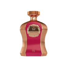 An image of a striking perfume bottle from Afnan Perfumes named "Highness Maroon IX". The bottle has a bold maroon center with a rose gold textured metallic finish on the edges. It features a crown emblem within an ornate frame on the maroon label, with the word "HIGHNESS" prominently displayed. The top of the bottle is adorned with a smooth rose gold cap. 