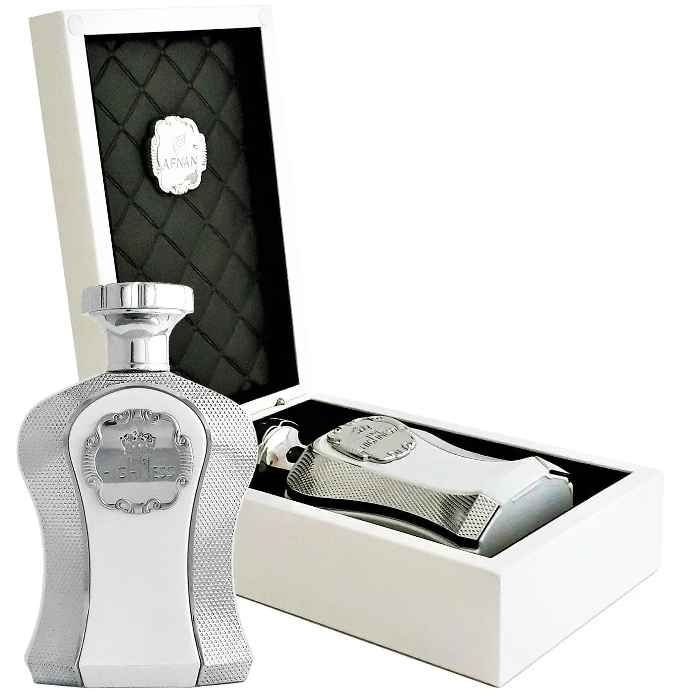 The image displays a luxurious perfume set featuring a sleek, silver bottle with a textured design and a regal-looking crest labeled "Highness" on the front. The bottle has a shiny silver cap and is presented in an open white box with a black quilted interior, which adds to the elegance of the product. A matching accessory, possibly a perfume applicator or a smaller bottle, rests beside the main perfume bottle inside the box. 