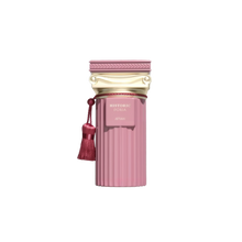The image features a perfume bottle from the Afnan "Historic Doria" collection. The bottle is pink with a ribbed texture, evoking a classic fluted column design. Topped with a golden cap styled with classical architectural motifs, it exudes a sense of antique elegance. A tasseled pompom hangs from the neck of the bottle, adding an element of decorative flourish typical of historical luxuries. 