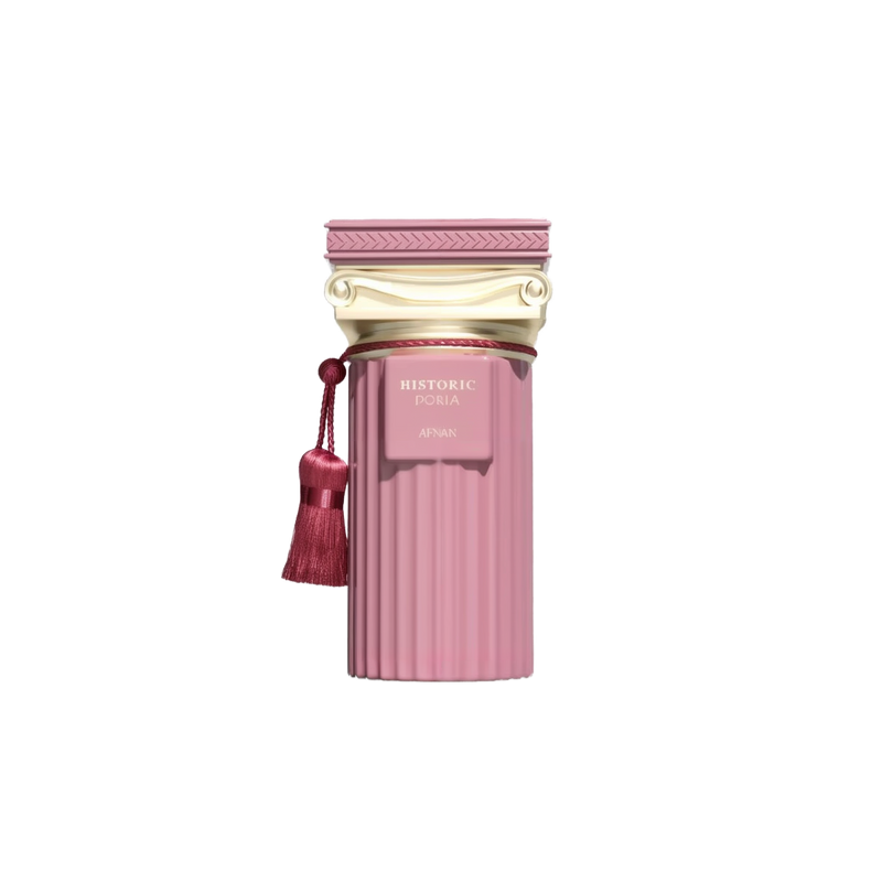 The image features a perfume bottle from the Afnan "Historic Doria" collection. The bottle is pink with a ribbed texture, evoking a classic fluted column design. Topped with a golden cap styled with classical architectural motifs, it exudes a sense of antique elegance. A tasseled pompom hangs from the neck of the bottle, adding an element of decorative flourish typical of historical luxuries. 