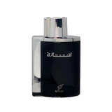 The image shows a rectangular perfume bottle with a dark, opaque body and a metallic silver cap. The front of the bottle has white Arabic calligraphy on the upper part and the word "AFNAN" in uppercase letters at the bottom, with a small rose emblem above it. The background is solid black, which provides a stark contrast to the bottle and highlights its features.