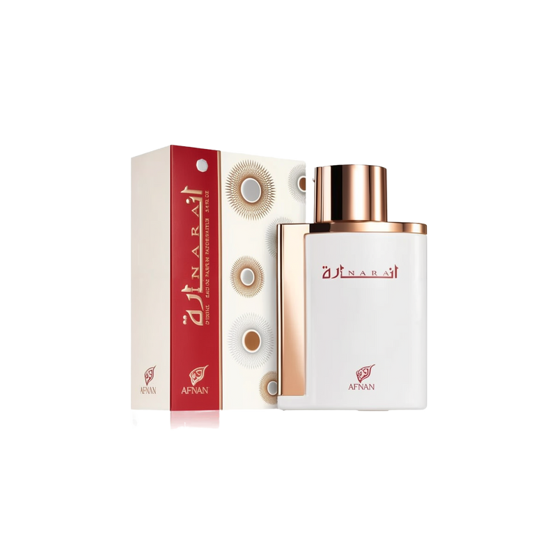 The image showcases a perfume bottle and its packaging. The bottle has a flat, rectangular shape with rounded edges, featuring a glossy white finish and a metallic rose gold cap. The front of the bottle displays the perfume's name "?????" in elegant red Arabic script, with the "AFNAN" logo in red below. Accompanying the bottle is its box, which has a white background with geometric circular patterns and a bold red side panel where the perfume's name and brand logo are repeated in white and red.