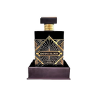 Infini Elixir by Maison Alhambra - a luxurious black perfume bottle with gold geometric patterns, displayed in a matching base. The bottle features a sophisticated rectangular design with a bold label at the center, highlighting the opulent and high-end nature of this fragrance. The set emphasizes elegance and exclusivity.