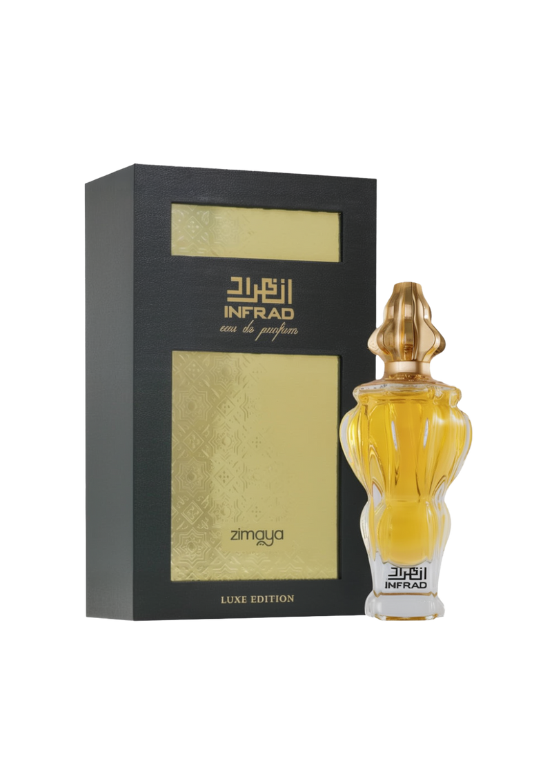 A bottle and packaging of Infrad Luxe Edition Eau De Parfum by Zimaya. The perfume bottle features an elegant, sculpted clear glass design filled with a rich golden liquid, and is topped with a uniquely shaped gold cap. The bottle is labeled “Infrad” in bold black Arabic and English script. The accompanying box is black with gold embossed panels and accents, prominently showcasing the name “Infrad” and “Luxe Edition,” giving the product a premium and luxurious appearance.