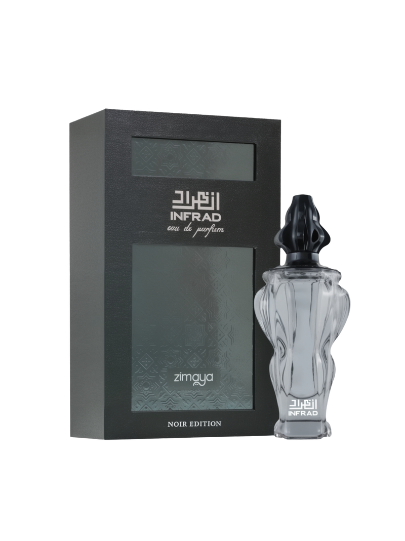 A product image of Infrad Noir Edition Eau De Parfum by Zimaya, featuring a sophisticated black and silver theme. The perfume bottle is crafted from clear glass with an intricate, sculpted design and topped with a glossy black cap. The matching box is matte black with silver embossed detailing and elegant Arabic calligraphy, prominently displaying the product name “Infrad Noir Edition” and brand “Zimaya.”