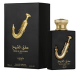 The image features the packaging and bottle of "Ishq Al Shuyukh Gold" Eau de Parfum by Lattafa Pride. On the left is the perfume's black box with a gold image of a traditional Arabic dagger and the perfume's name in Arabic calligraphy and English. The box