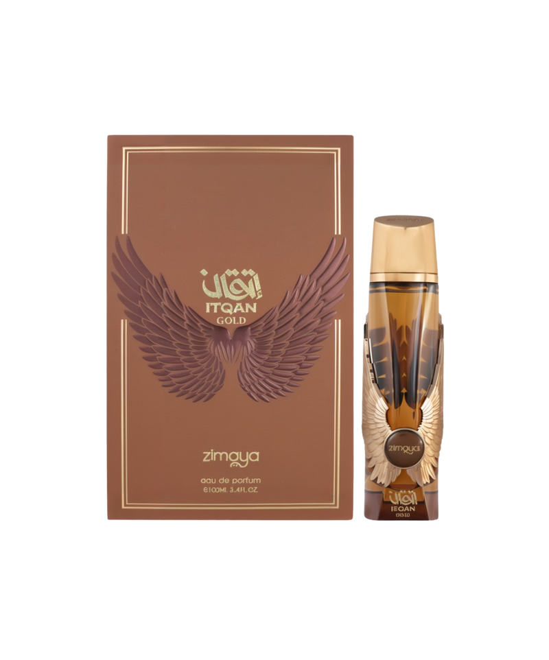 A bottle and packaging of Itqan Gold Eau De Parfum by Zimaya. The perfume bottle is amber-toned with golden accents, including a gold cap and metallic wing embellishments on the sides. The front label reads "Itqan Gold" and "Zimaya." The matching brown box features embossed wings in a darker brown tone, gold text, and decorative borders. The overall presentation suggests a luxurious and bold fragrance with a regal and powerful aesthetic.