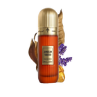 This image features a tall, cylindrical perfume bottle with a gold cap, labeled "Jamaican Tobacco" by Ibraheem Al Qurashi. The bottle is amber-colored with a textured surface, and it shows the volume as "100 ml / 3.4 fl.oz." A dry tobacco leaf, some lavender sprigs, and pieces of amber resin are placed around the bottle, suggesting the scent notes of the fragrance.