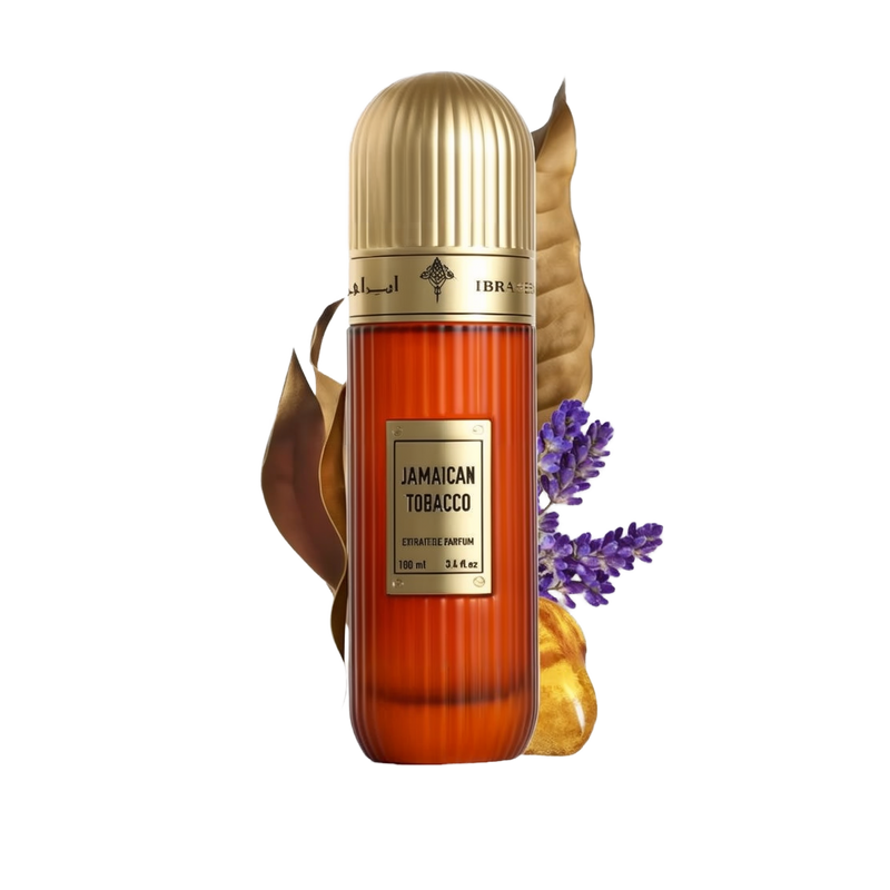 This image features a tall, cylindrical perfume bottle with a gold cap, labeled "Jamaican Tobacco" by Ibraheem Al Qurashi. The bottle is amber-colored with a textured surface, and it shows the volume as "100 ml / 3.4 fl.oz." A dry tobacco leaf, some lavender sprigs, and pieces of amber resin are placed around the bottle, suggesting the scent notes of the fragrance.