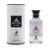 A 100 ml bottle of Jean Lowe Matière Eau de Parfum by Maison Alhambra. The packaging includes a white cylindrical container with black trim. The transparent glass bottle contains a light purple fragrance, and it features a black cap and a black square label with the brand name and logo.