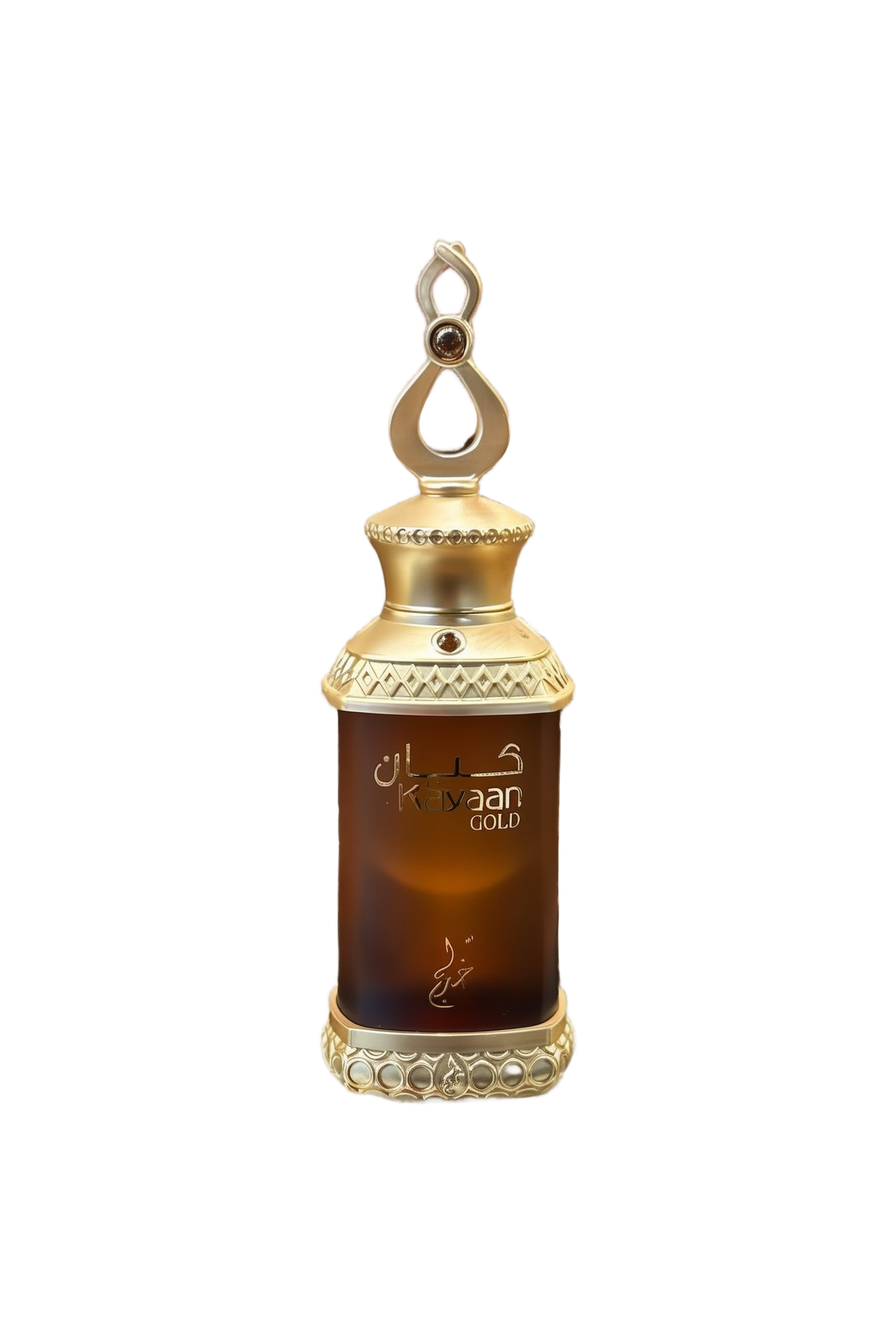 This image features a perfume bottle labeled "Kayaan Gold" resting on a glass surface. The bottle has a regal design with a gold-toned cap adorned with decorative elements and a loop on top, suggesting it can be used as a pendant or for easy carrying. The dark amber liquid inside indicates the perfume might have a rich and possibly woody or oriental fragrance.