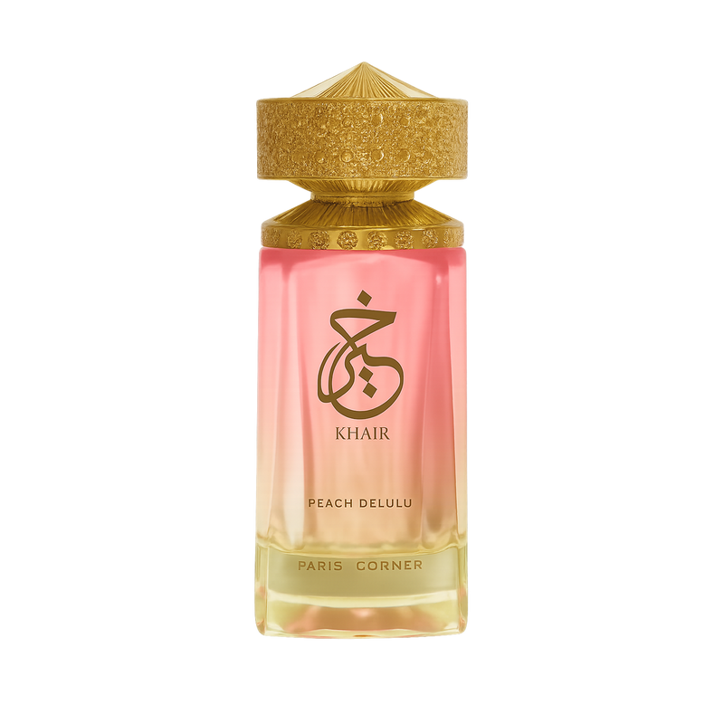 Gold-capped Khair Peach Delulu perfume bottle with pink to gold gradient glass on dark backdrop.