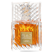 Lattafa Khamrah fragrance in a faceted clear glass bottle filled with rich amber liquid and featuring a gold label.