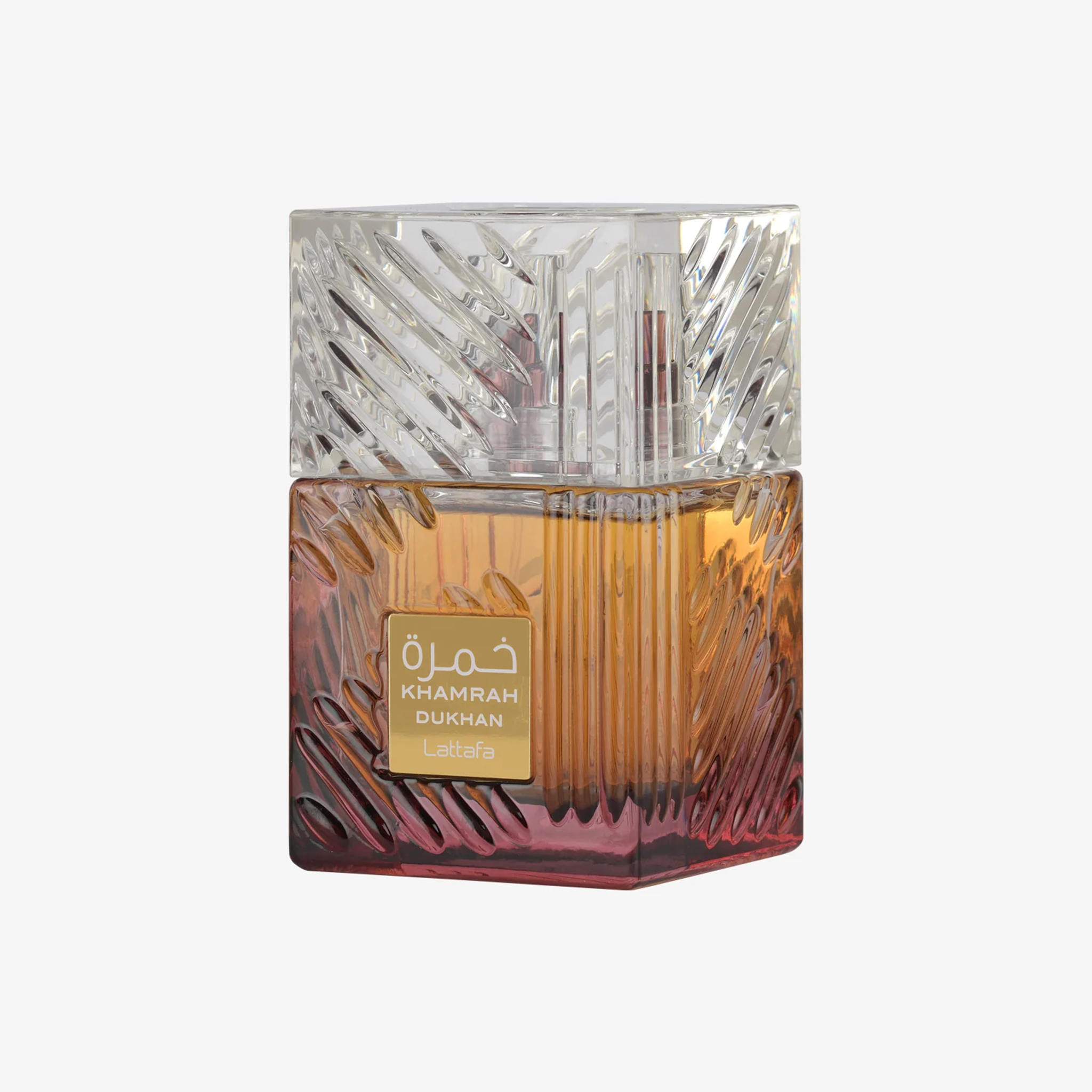 A square glass perfume bottle of Khamrah Dukhan, with an intricate glass design with a gradient color.