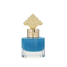 This image features a square-shaped perfume bottle with a blue gradient color, transitioning from a darker blue at the top to clear at the bottom. The cap is gold with intricate, ornate patterns resembling traditional Arabic designs. Arabic script is present on the gold band just below the cap, likely denoting the brand or fragrance name.