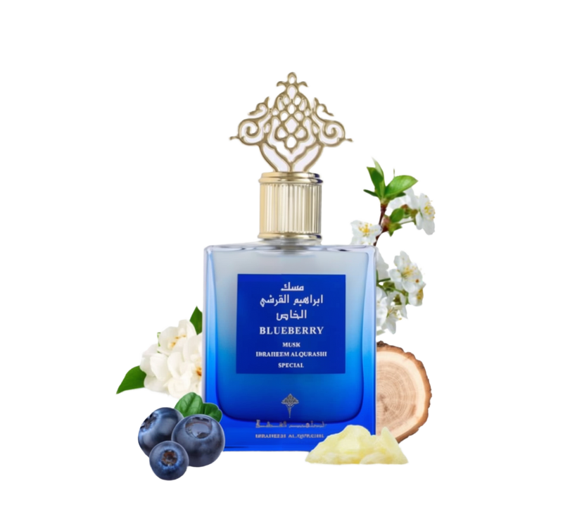 Perfume Blueberry Musk by Ibraheem Al Qurashi around the bottle are blueberries, a wood slice & flowers, set against a clean white background.