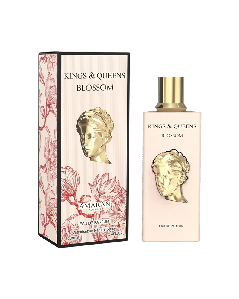A rectangular pale pink perfume bottle featuring a gold bust design on the front and a gold cap stands next to a matching box. The box, edged in black, is decorated with red floral outlines and displays the product name “Kings & Queens Blossom” along with the brand “Amaran.”