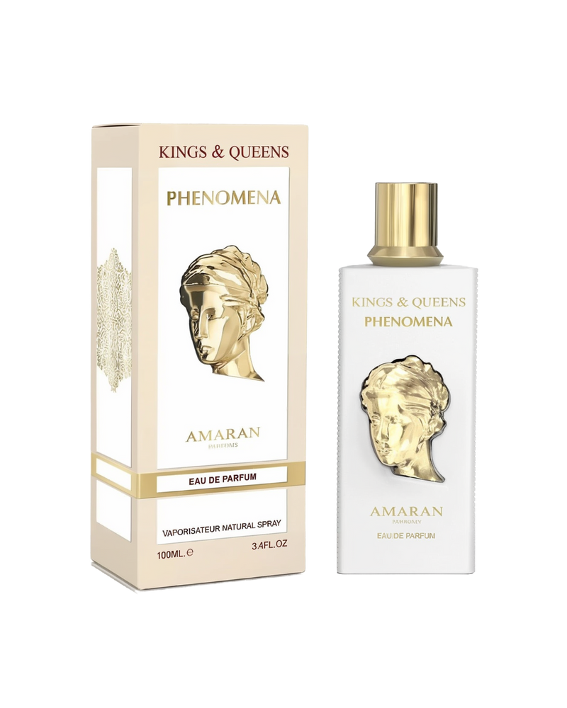 A rectangular white perfume bottle with a gold cap and a gold classical bust design on the front stands next to a matching white box with gold detailing. Both feature the text “Kings & Queens Phenomena” and the brand name “Amaran” in gold lettering.