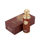 The image features "La Luna" by Gissah, displayed alongside its packaging. The perfume bottle is a sleek copper color with a gold ornate medallion and an intricately designed gold spherical cap. The packaging is a deep brown box with a textured surface and a large gold circular mandala design on the top. The box also has the name "Gissah" and "LA LUNA" along with the description "SIGNATURE COLLECTION LIGHT FRAGRANCE."