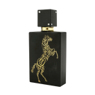 A sleek black bottle of Lail Maleki Eau de Parfum by Ard Al Zaafaran, featuring an elegant gold design of a rearing horse made up of intricate Arabic calligraphy. The bottle has a textured finish and a square black cap adorned with small silver accents. The luxurious and artistic design of the bottle highlights the sophistication and exclusivity of the fragrance.