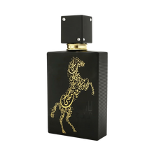 A sleek black bottle of Lail Maleki Eau de Parfum by Ard Al Zaafaran, featuring an elegant gold design of a rearing horse made up of intricate Arabic calligraphy. The bottle has a textured finish and a square black cap adorned with small silver accents. The luxurious and artistic design of the bottle highlights the sophistication and exclusivity of the fragrance.