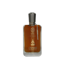 The image features a sleek glass perfume bottle with a rich, amber-hued liquid inside. The front of the bottle displays the word "LEEL" in large, bold letters, with "INTENSE" just beneath it in a smaller font. Below this, the "DKHAN FRAGRANCES" emblem is prominently centered. At the top of the bottle, a golden geometric design is visible. The cap is a faceted black design, suggesting a luxurious and modern aesthetic. 