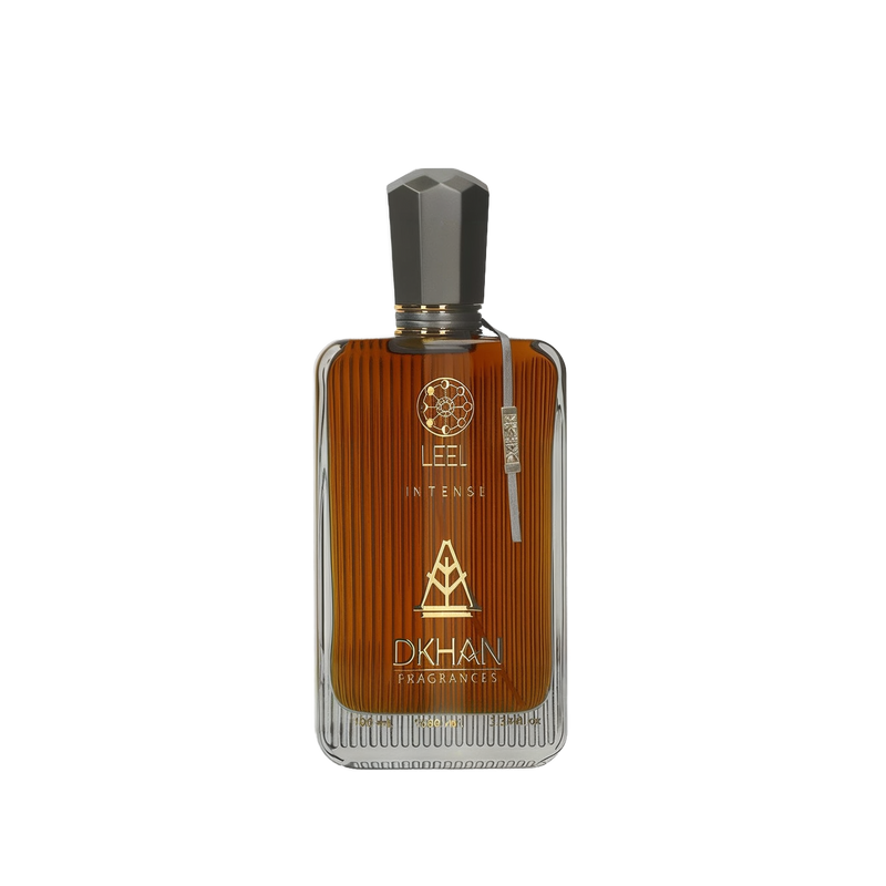 The image features a sleek glass perfume bottle with a rich, amber-hued liquid inside. The front of the bottle displays the word "LEEL" in large, bold letters, with "INTENSE" just beneath it in a smaller font. Below this, the "DKHAN FRAGRANCES" emblem is prominently centered. At the top of the bottle, a golden geometric design is visible. The cap is a faceted black design, suggesting a luxurious and modern aesthetic. 