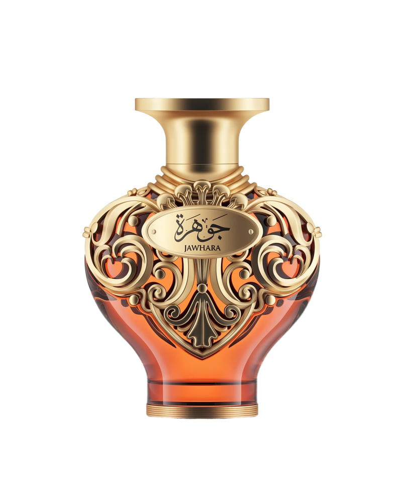 A product shot of Le Falcone Niche Collection’s “Jawhara” perfume bottle against a white background: a heart-shaped amber glass vessel topped with a wide, gold-tone cap. The bottle’s upper half is wrapped in ornate gold filigree with elegant arabesque scrollwork, featuring an oval plaque engraved with Arabic calligraphy above the word “Jawhara.”