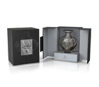 A product shot of Le Falcone’s “Sultan” niche-collection perfume: a matte black rectangular gift box with a silver plaque bearing Arabic script and the word “Sultan” sits closed on the left. On the right, the box is open to reveal an ornate, heart-shaped glass perfume bottle adorned with intricate silver filigree and a matching “Sultan” label, nestled on a light grey interior platform.