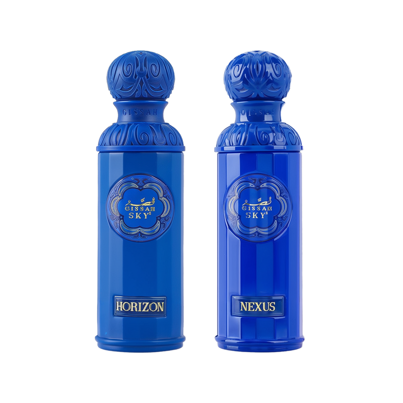 The image displays two perfume bottles from the "Legend of the Sky" collection by Gissah, named "Horizon" and "Nexus." Both bottles are vibrant blue with a tall, cylindrical shape and an ornate, embossed cap. The front of each bottle features an ornamental gold emblem with the collection's name, "GISSAH SKY," and each has a gold label with the individual fragrance's name. 