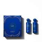 The image shows the "Legend of the Sky" perfume set by Gissah, which includes two blue bottles labeled "Nexus" and "Horizon." The bottles are set against a blue box with elegant gold and white detailing and the collection name "Legend of the Sky" prominently featured in the center. The design of the box mirrors the ornate style of the bottles' caps, creating a cohesive and visually appealing presentation that suggests a luxurious fragrance experience.