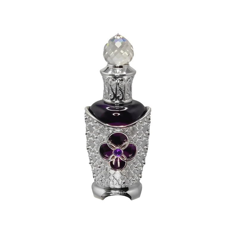 The image features an ornate perfume bottle. The bottle has a dark body with a silver filigree design encrusted with crystals, highlighting a prominent purple flower-shaped jewel at the center. It's topped with a faceted crystal cap that adds to the luxurious appeal. The intricate details suggest a bespoke and opulent scent contained within. The overall design of the bottle conveys a sense of vintage elegance and exclusivity.