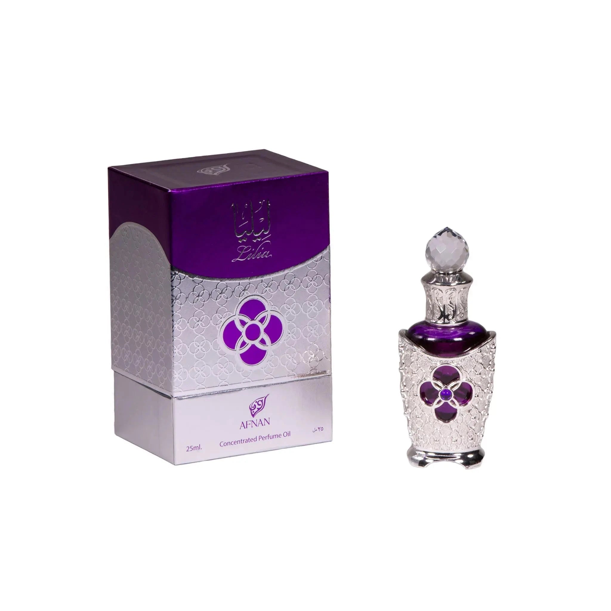 The image displays a luxurious Lilia Concentrated Perfume Oil by Afnan, alongside its packaging. The perfume bottle is ornate with a silver filigree design and a prominent purple jewel in the shape of a flower. It is topped with a crystal-like cap. The packaging mirrors the bottle's elegance, with a silver and purple design and the Afnan logo. The perfume container and its box together suggest a premium, richly scented oil, combining traditional Middle Eastern aesthetics with modern luxury.