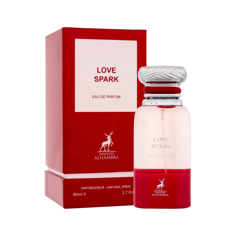 A red and white rectangular perfume box labeled “Maison Alhambra Love Spark Eau De Parfum” stands next to a cylindrical glass bottle with a silver ridged cap and a red gradient at the base, displaying the same product name.