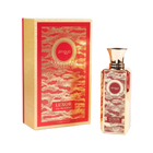 The image shows a bottle of "Luxor" eau de parfum by Zimaya alongside its packaging. The perfume bottle is tall and rectangular with a gold cap, featuring an ornate red and gold label with the brand name "zimaya" in a circular emblem near the top. The word "Luxor" is written in bold at the bottom of the label, along with "eau de parfum." The packaging box matches the bottle's design, with a red and gold pattern and similar branding elements.