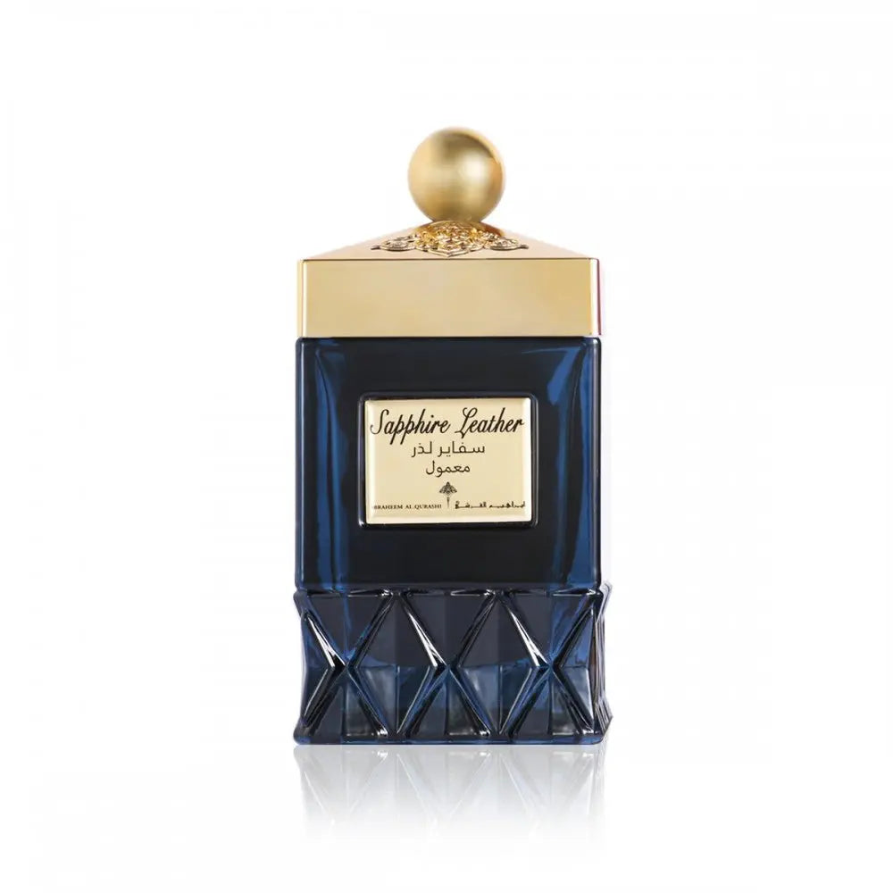  The image shows an elegant dark navy blue perfume bottle on a white background. The bottle features a faceted design on its lower half that resembles a cut gemstone. The upper half of the bottle is smooth and sports a golden label with the name "Sapphire Leather" in both English and Arabic script. Atop the bottle is a gold cap with intricate detailing, finished with a spherical knob.  