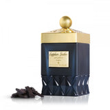 The image displays an elegant dark blue perfume bottle on a white background. The bottle has a faceted base with a diamond-cut design, giving it a luxurious and textured look. The upper portion of the bottle is smooth and features a gold label with "Sapphire Leather" written in English and Arabic script, indicating the fragrance's name. The cap is golden and embellished with a pattern, topped with a spherical golden knob. 