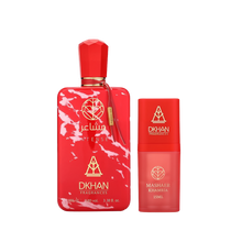This image features a striking fragrance set from DKHAN Fragrances. On the left, there's a large red perfume bottle with a marbled white pattern, labeled "club INTENSE" and displaying the DKHAN Fragrances logo, along with the quantity "100 ml, 3.38 fl. oz., 80% vol." The bottle has a rectangular shape with rounded edges and a geometric red cap, complemented by a gold tag. To the right is a smaller, cylindrical red bottle with a smooth finish, labeled "MASHAER KHAMRIA" and the volume "15ML".