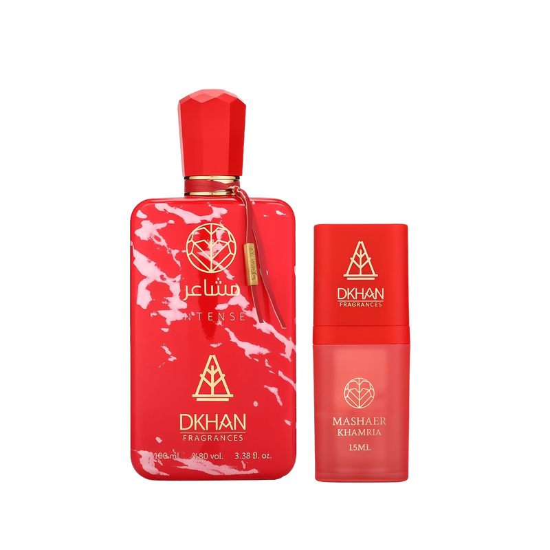 This image features a striking fragrance set from DKHAN Fragrances. On the left, there's a large red perfume bottle with a marbled white pattern, labeled "club INTENSE" and displaying the DKHAN Fragrances logo, along with the quantity "100 ml, 3.38 fl. oz., 80% vol." The bottle has a rectangular shape with rounded edges and a geometric red cap, complemented by a gold tag. To the right is a smaller, cylindrical red bottle with a smooth finish, labeled "MASHAER KHAMRIA" and the volume "15ML".