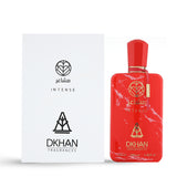  This image features a bold red perfume bottle with a marbled white pattern on the right and its corresponding packaging box on the left. The perfume bottle has a geometric cap and a gold label that reads "club INTENSE" and "DKHAN FRAGRANCES" with a heart inside a diamond logo, and additional text stating "100 ml, 3.38 fl. oz., 80% vol." The white box has the same logos and text "INTENSE" and "DKHAN FRAGRANCES" in a simple, elegant font.