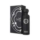 A sleek, cylindrical black perfume bottle with an ornate spherical cap, labeled “Gissah Mavro” in silver, standing next to a matching black box adorned with a stylized silver pattern.