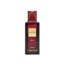 The image displays a sophisticated perfume bottle named "Modest Deux" by Afnan Perfumes. It features a deep burgundy color with a geometric cap that has a metallic finish and a diamond-like embellishment on top. The label is a simple gold plaque with the name "Modest" in elegant script, followed by "POUR FEMME" indicating it's for women, and "DEUX" beneath it. 