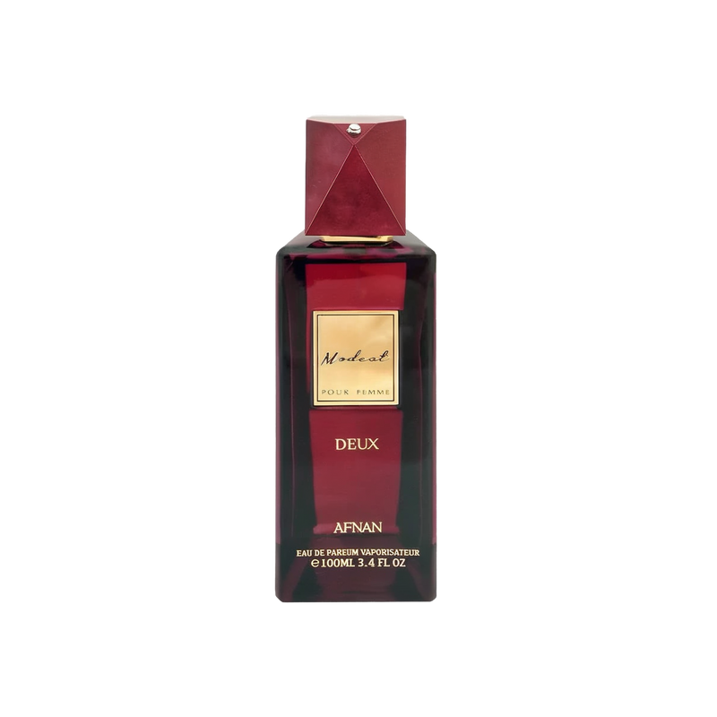 The image displays a sophisticated perfume bottle named "Modest Deux" by Afnan Perfumes. It features a deep burgundy color with a geometric cap that has a metallic finish and a diamond-like embellishment on top. The label is a simple gold plaque with the name "Modest" in elegant script, followed by "POUR FEMME" indicating it's for women, and "DEUX" beneath it. 