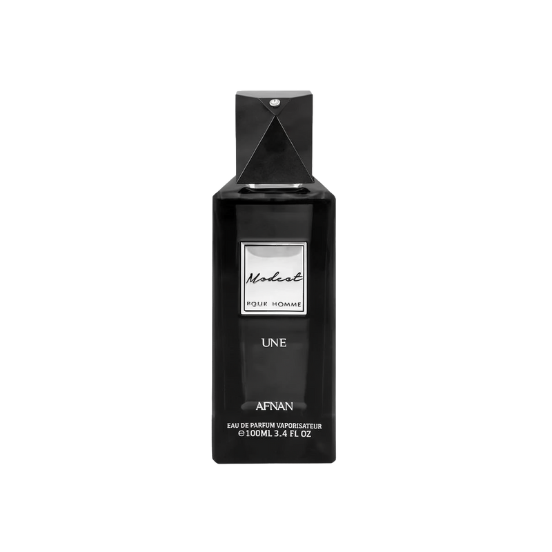 The image is of a black perfume bottle for "Modest UNE" by Afnan Perfumes. The bottle has a sleek, rectangular shape with a black cap and a diamond-like embellishment on the top. The label on the bottle is white with black lettering that reads "Modest" in