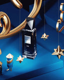 The image features a dark blue bottle of "Modest UNE" eau de parfum for men by Afnan Perfumes, placed on a reflective blue surface with a dynamic blue background. The bottle has a distinctive silver cap and a clear label that matches the overall aesthetic of the product. Surrounding the bottle are decorative elements: suspended golden stars and curved golden ribbon shapes that create an opulent, festive atmosphere.