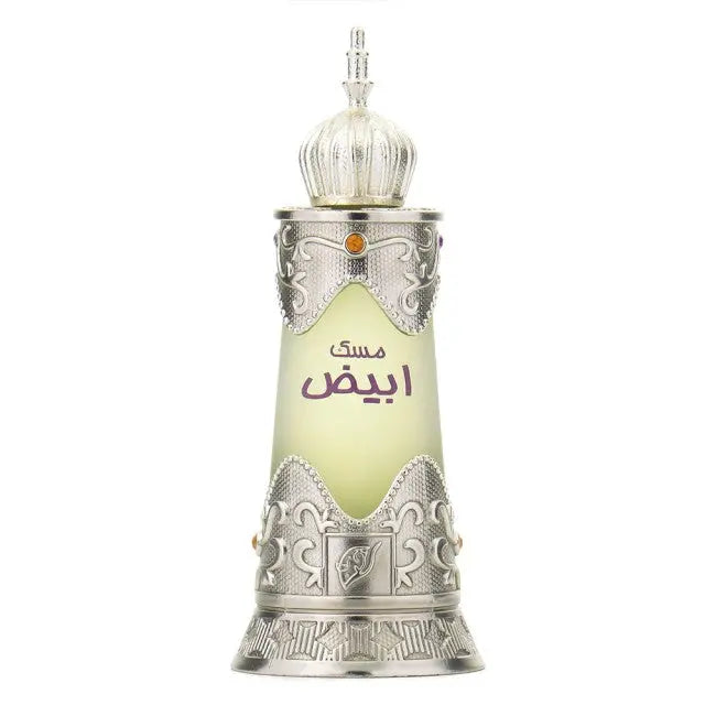 The image displays a bottle of "Musk Abiyad" concentrated perfume by Afnan Perfumes. The design of the bottle is reminiscent of traditional Middle Eastern art, with a silver ornamental finish and elaborate scrollwork. It features a dome-shaped cap and a semitransparent section in the middle where the perfume liquid is visible, which graduates from clear to a light green hue. Arabic calligraphy in purple is prominently displayed on the bottle, suggesting the name of the fragrance or the scent note. 