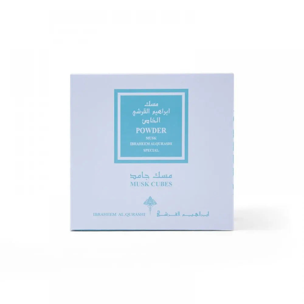 The image shows a light blue square packaging box for a product labeled in both Arabic and English. The label reads "Powder Musk, Ibraheem Al Qurashi Special" with "Musk Cubes" noted at the bottom. The design is simple with a teal frame surrounding the text on the box. The background is white, highlighting the soft blue color of the packaging.