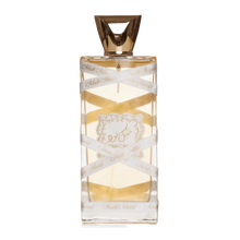 The image displays a rectangular perfume bottle with a golden-yellow liquid inside. The cap is a geometric, faceted gold design. A white ribbon with the text "Musk Mood" in a repeating pattern wraps around the bottle. Additionally, a decorative gold label with elaborate borders and an emblem is affixed to the center of the bottle.