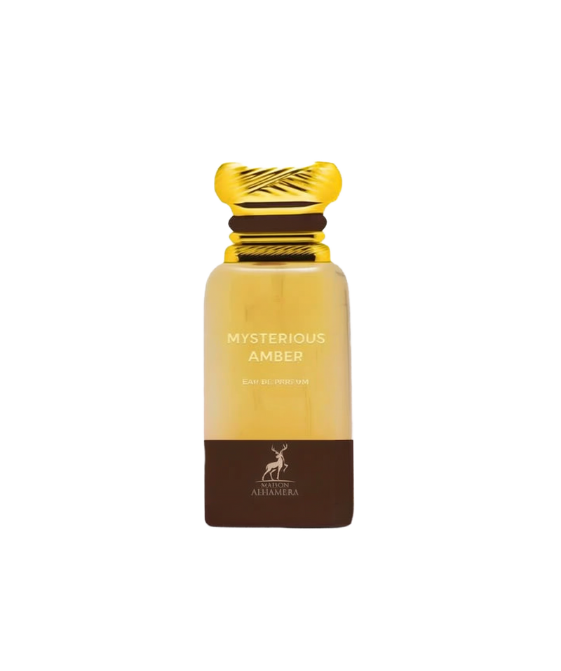 A tall rectangular perfume bottle with a metallic gold cap, featuring a warm amber-colored glass body and a dark brown band at the base. The label reads “Mysterious Amber” by Maison Alhambra.